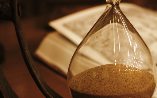 Picture of hourglass with Bible in the background